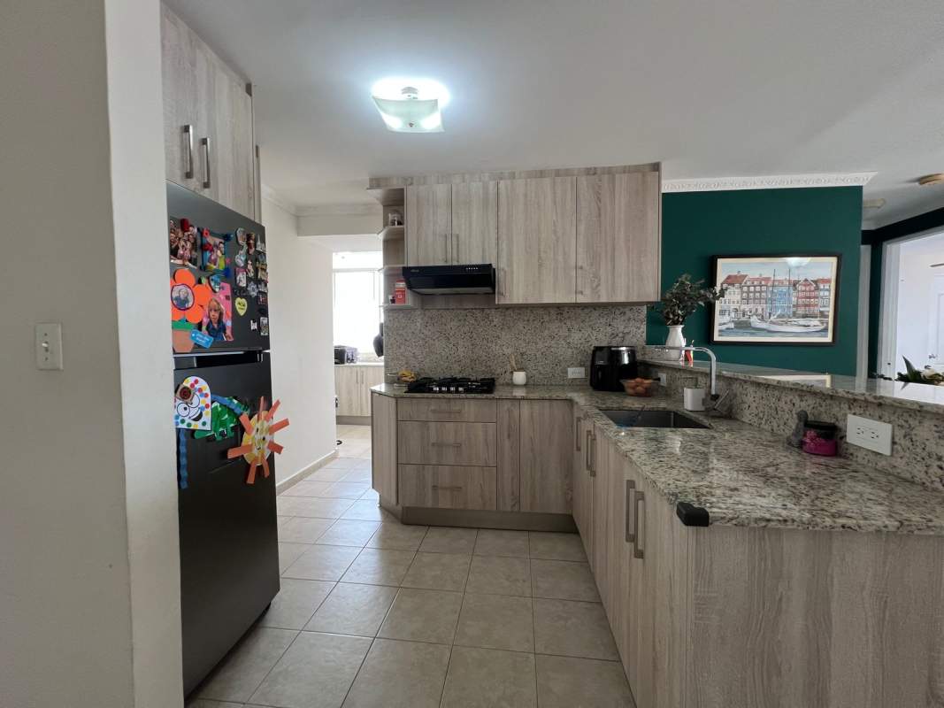Modern laundry room with city skyline view washer dryer cabinets granite counter Panama
