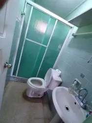 Small bathroom with glass shower white fixtures Herrera Santiago Panama rental