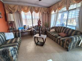 Bright living room striped couch large windows curtains Santiago Panama rental