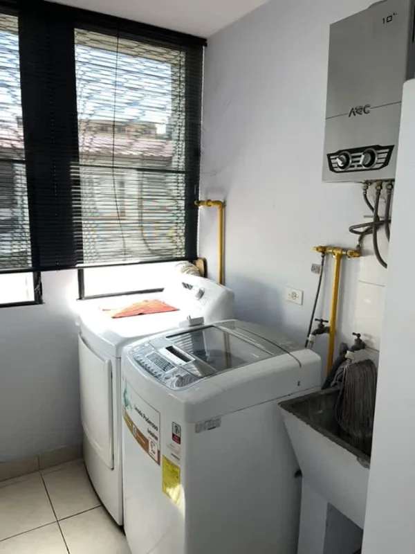 Laundry room with washer, dryer, water heater, window in apartment PH La Loma Tower Panama
