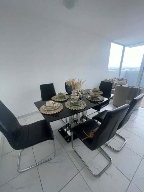 Open plan living-dining with panoramic windows and minimalist decor in PH Río Abajo Panama