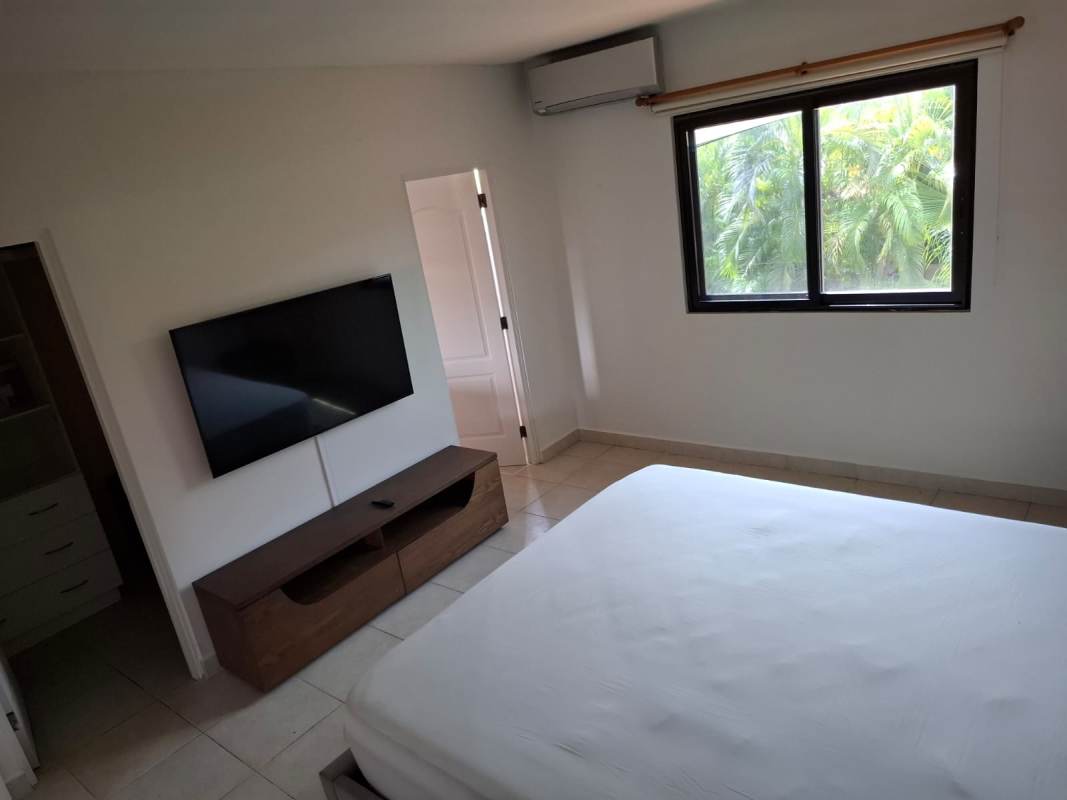 Master bedroom with walk-in closet, large window, and tile flooring rental Panama