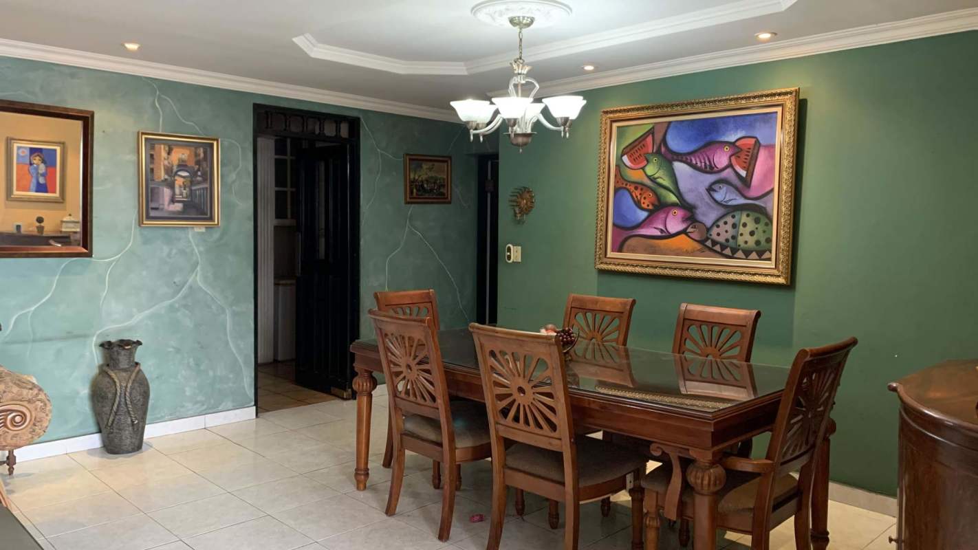 Elegant living room with leather sofas, panoramic windows, and city view at PH Señorial 50 Panama City