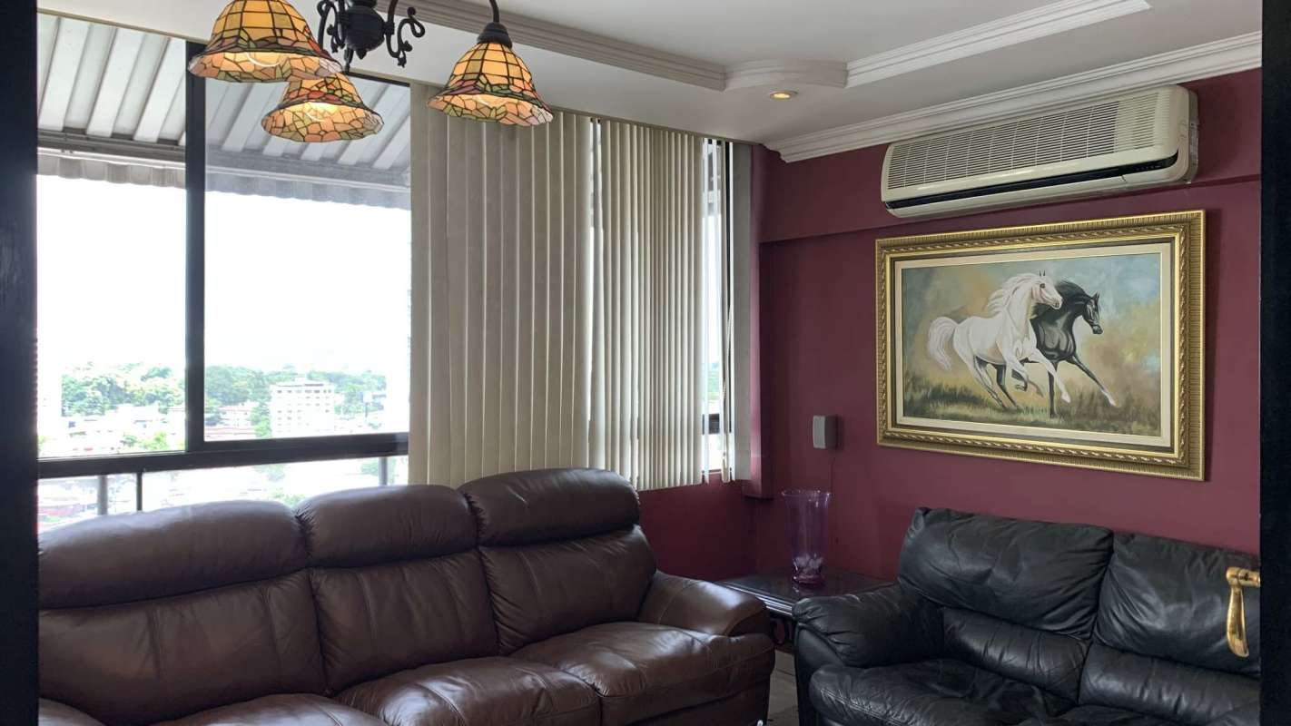 Second living room with pendant lamps, panoramic windows and leather seating in PH Señorial 50 San Francisco Panama