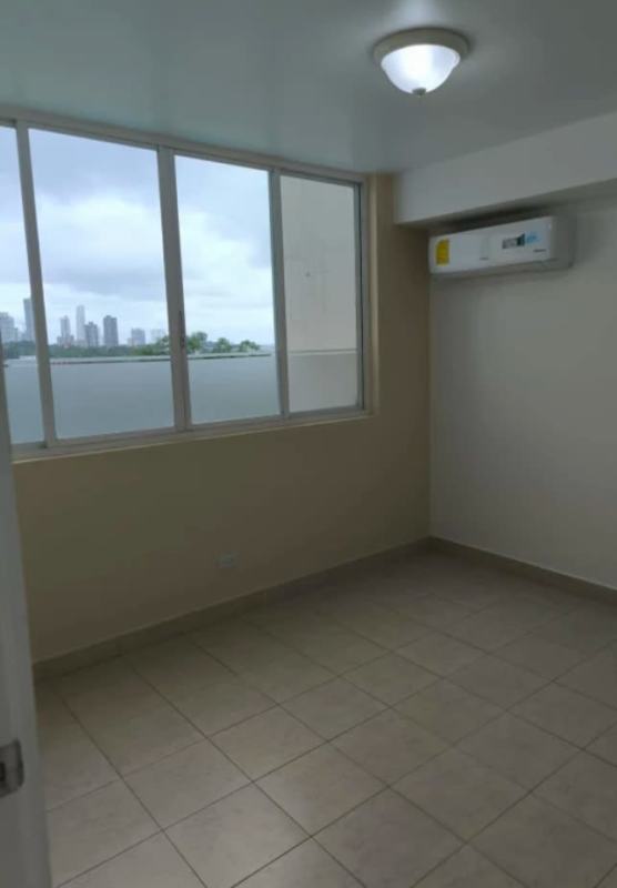 Empty bedroom with tiled floors, AC, large windows with city views in PH Edison Park Panama