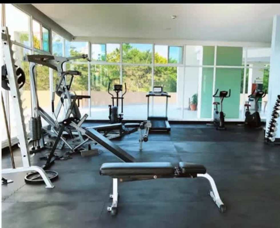 Modern gym with cardio equipment, weights, natural light PH Edison Park Panama