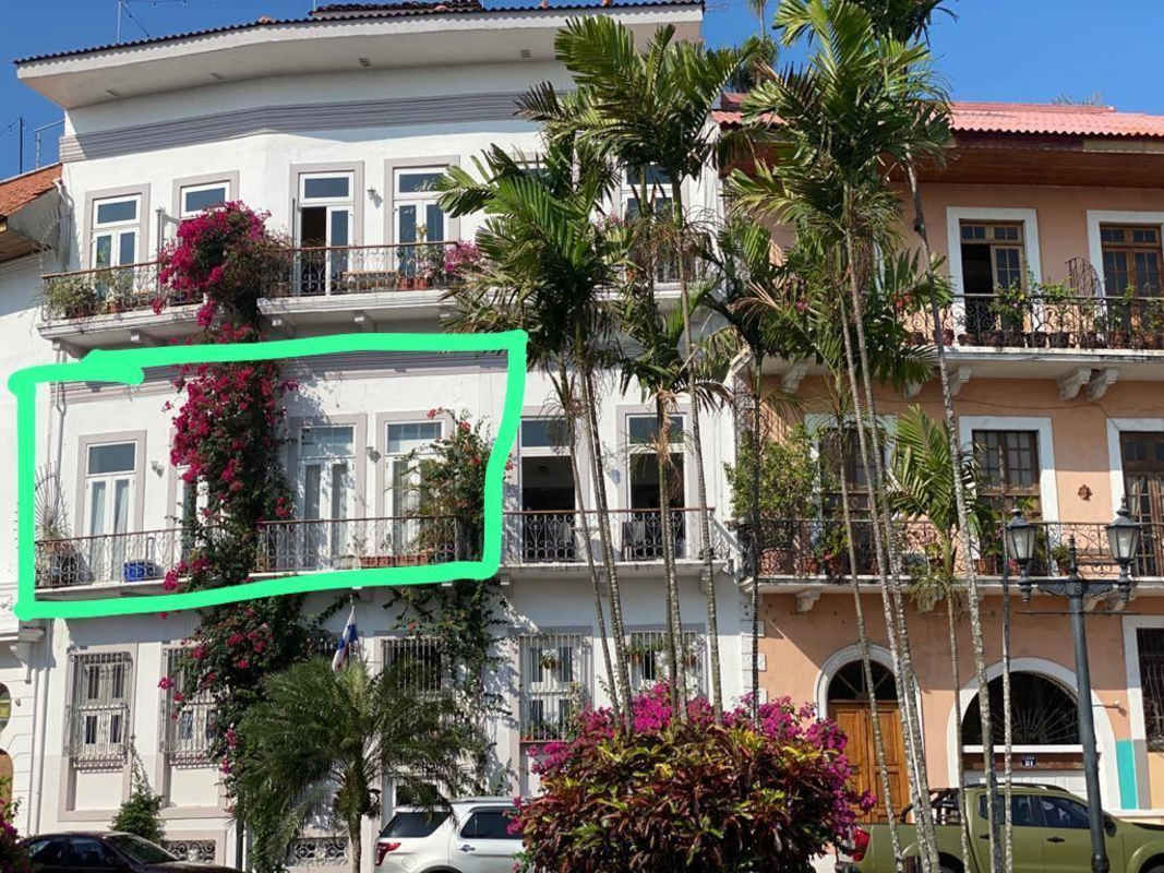 Historic colonial white facade with balconies, bougainvillea vines in Casco Viejo Panama