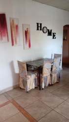 Glass top dining set with slipcovered chairs Barrio del Maestro Sabanitas