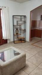 Living room with sofa and view to kitchen in furnished apartment Barrio del Maestro Sabanitas