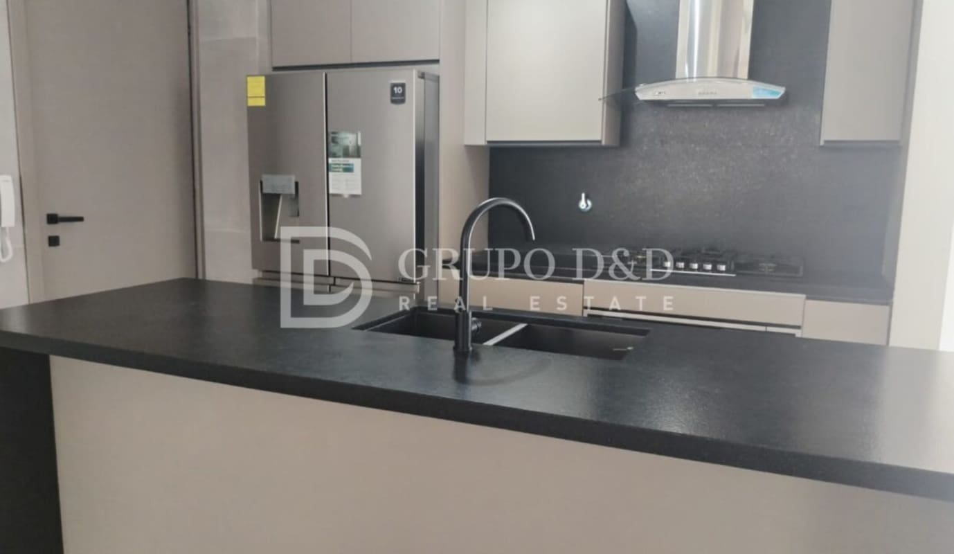 Contemporary kitchen with island sink, range hood and stainless fridge PH Victory Wellness Coco del Mar Panama