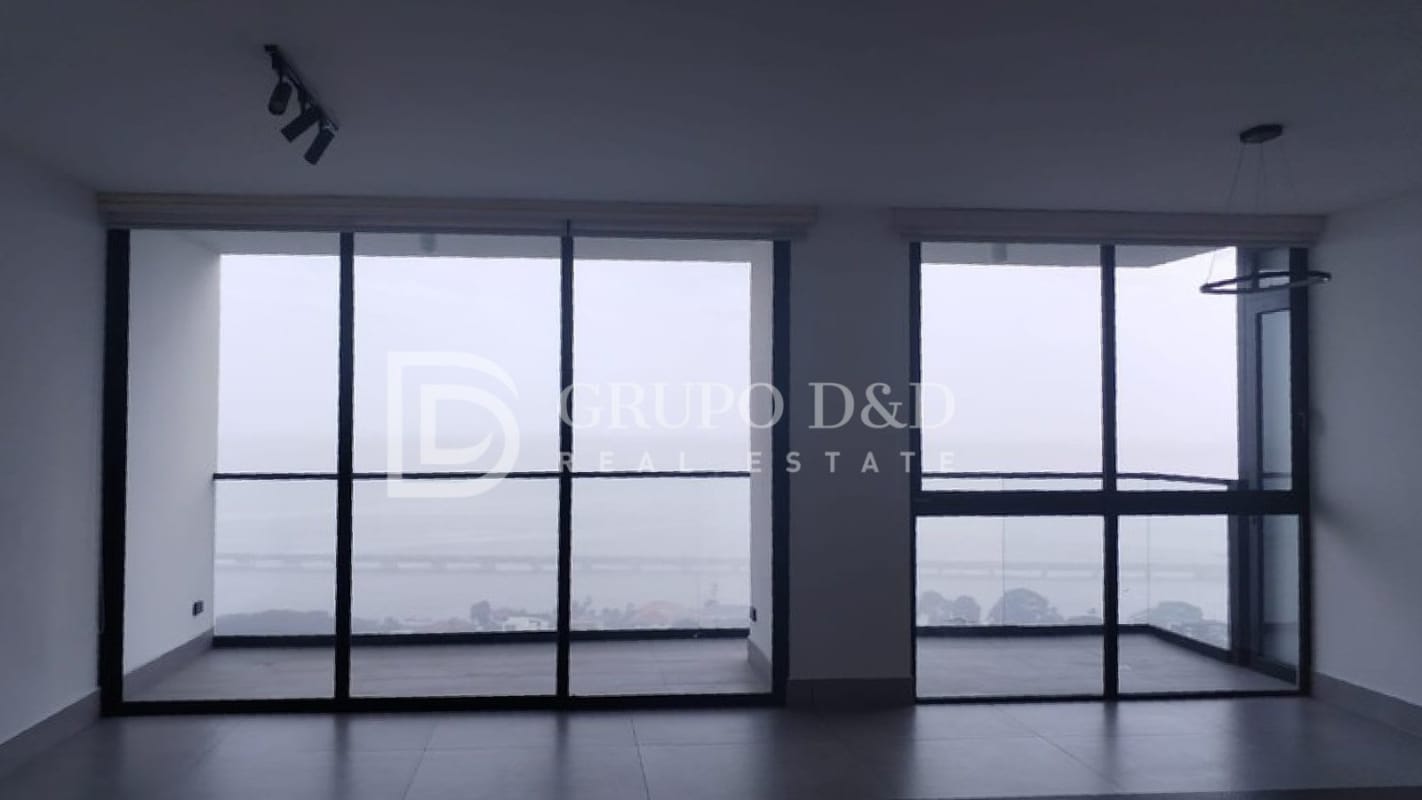 Modern living room with floor-to-ceiling windows overlooking ocean in Victory Wellness Tower Panama City