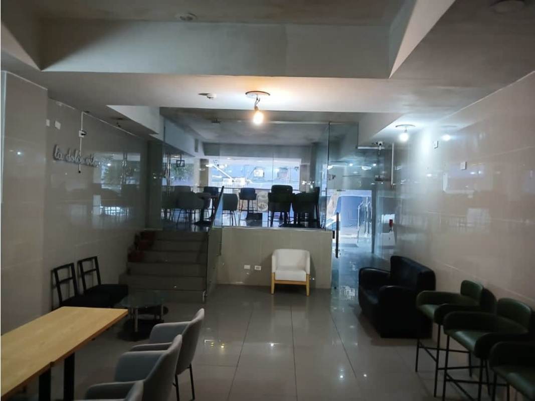 Modern lobby area with glass partition, minimalist seating at commercial space in Panama City