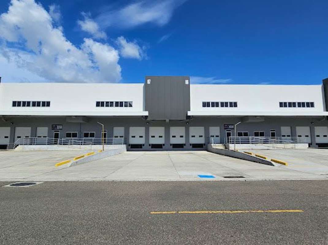 Modern warehouse exterior featuring large loading bays, truck ramp and secure entry in South Park Industrial Zone Costa Sur Panama