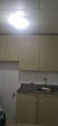 Simple kitchen with overhead cabinets and granite countertop in Lago Emperador house