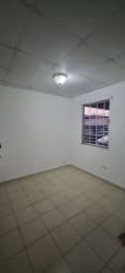 Simple empty bedroom with tiled floor and window bars in Lago Emperador Arraiján house for rent