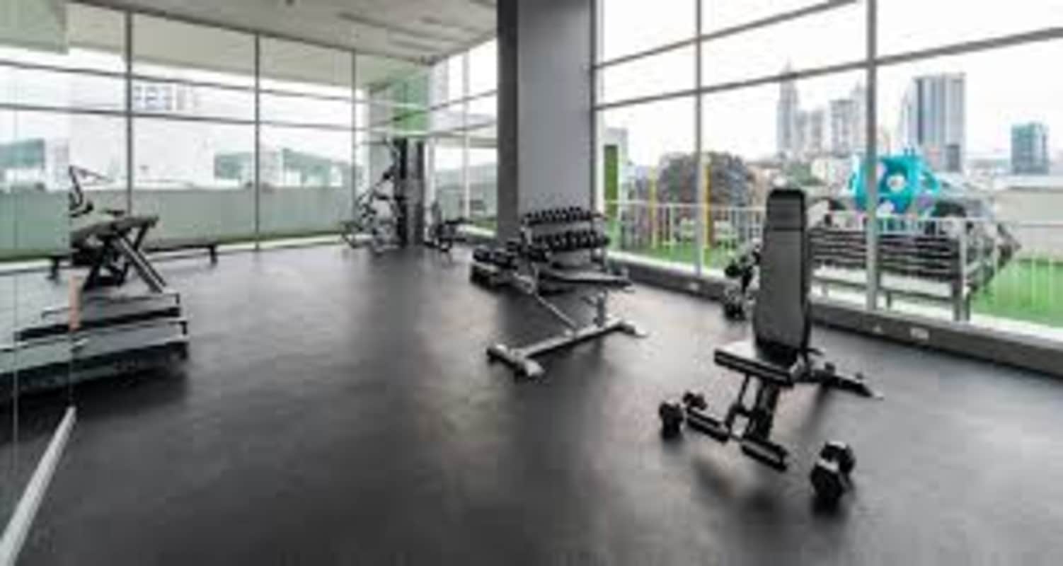 Modern high-rise condominium tower with balconies and glass windows in Edison Park Panama