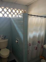 Traditional orange home facade with gated driveway in Chame Panama