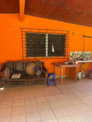 Backyard patio area with orange walls and outdoor sink at Chame house for sale