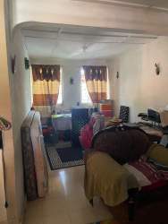 Single-story orange house with carport seen from the street in Chame Panama