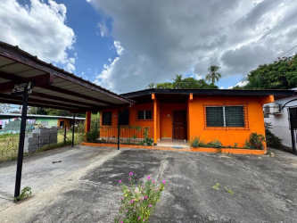 Small bathroom with blue tile shower, sink, and toilet in Chame house for sale