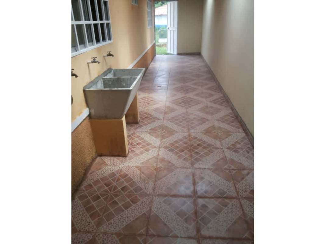 Laundry area with utility sink, tiled floor corridor Barriada Belmonte Panama City