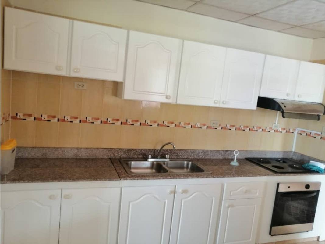 Kitchen with granite countertop, white cabinets, oven, cooktop Barriada Belmonte
