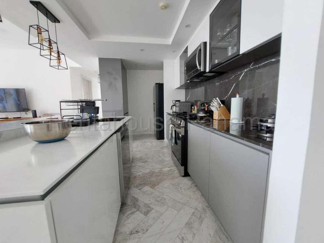 Modern kitchen with granite counter, stainless appliances at PH Quartz Tower San Francisco Panama