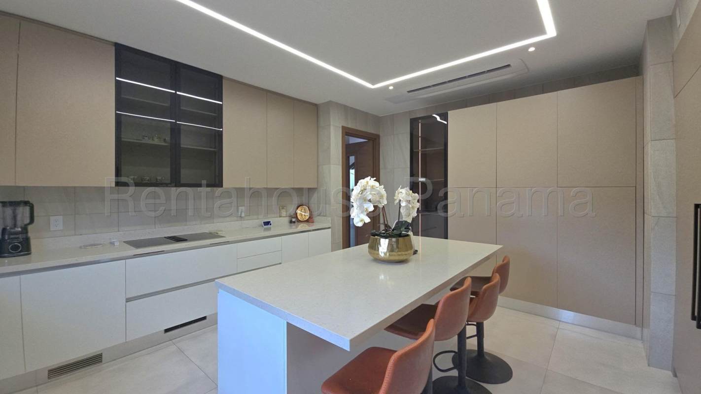 Open kitchen with island and premium Miele appliances in Santa Maria luxury home Panama
