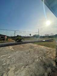 Living area with split AC unit, ceramic tile floor, window with park view in Brisas del Campo
