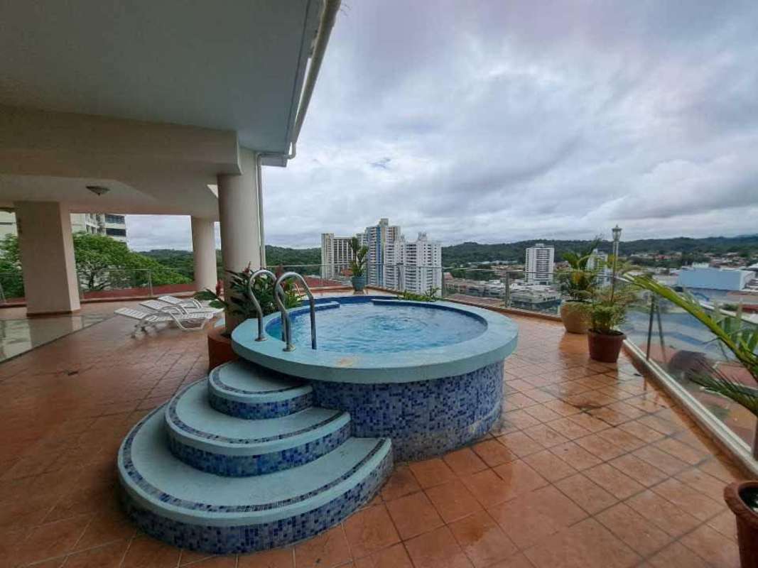 Minimalist kitchen opens to living dining room with ceiling fan PH Dos Mares View Betania Panama