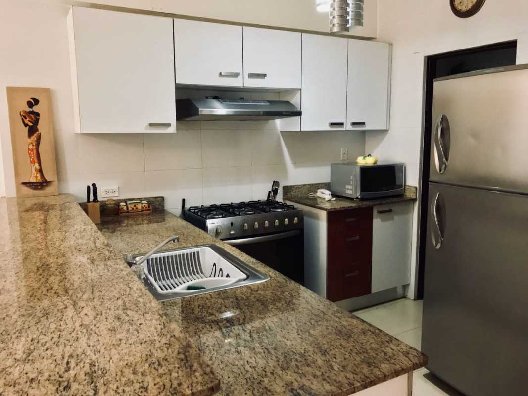 Bedroom with large window, closet, and ocean view PH Grand Bay Panama City