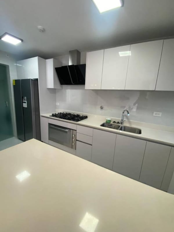 Kitchen island with marble countertop and appliances at PH Velure El Cangrejo Panama