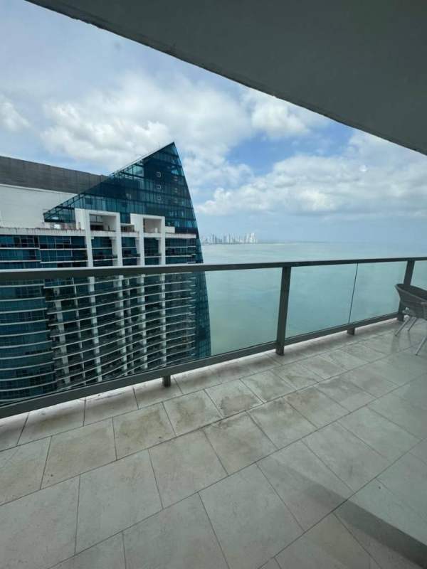 Living area with floor-to-ceiling windows and ocean skyline views at Trump JW Marriott
