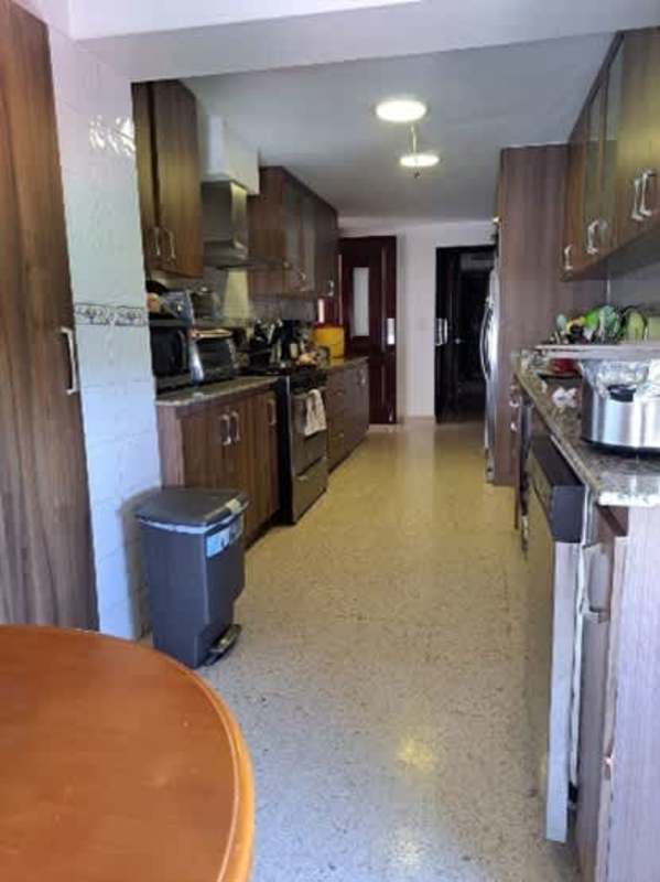 Spacious kitchen with granite countertops, wood cabinets in PH Marina del Rey Coco del Mar Panama City