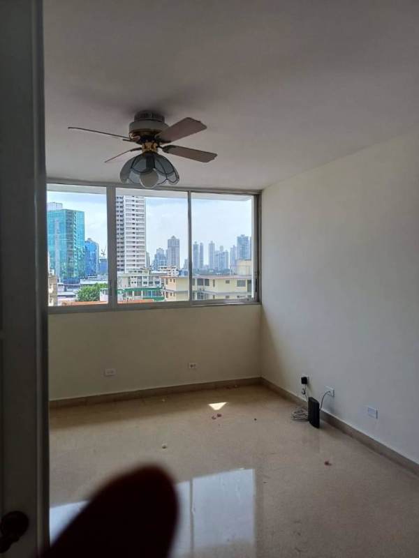 Kitchen with wooden cabinets, solid countertops and tiled backsplash in PH Royal Park Panama City