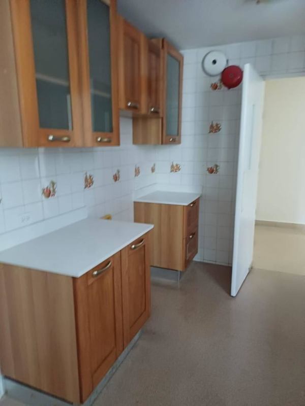 Kitchen with decorative tile backsplash and wood cabinetry Obarrio Panama