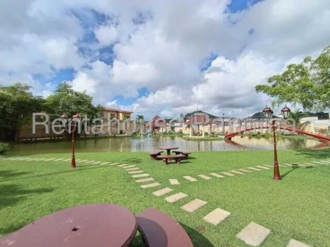 Outdoor swimming pool with palm trees in a secure residential community Dorado Lake Panama City