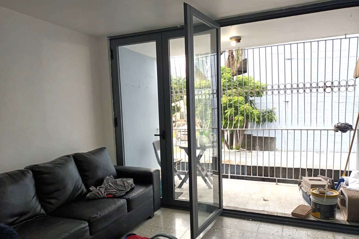 Facade of PH Palmas Bellas mid-rise building with balconies and security grilles in Parque Lefevre Panama City