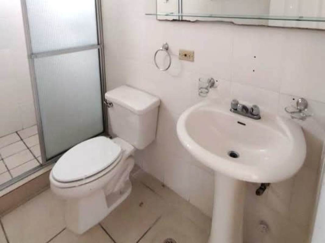 Tiled bathroom with pedestal sink and glass shower PH La Locería