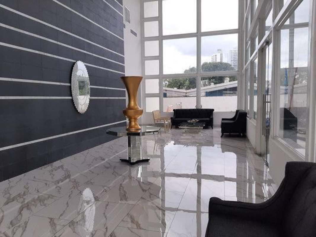 Lobby with marble flooring, decorative black wall, modern sofas at PH Vivendi Towers Panama