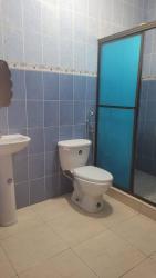 Bathroom with tile walls, pedestal sink and shower glass enclosure Gloria Lucrecia Chitré Panama