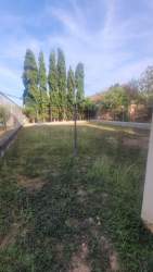 Large fenced backyard with trees and grass in Gloria Lucrecia Chitré Panama