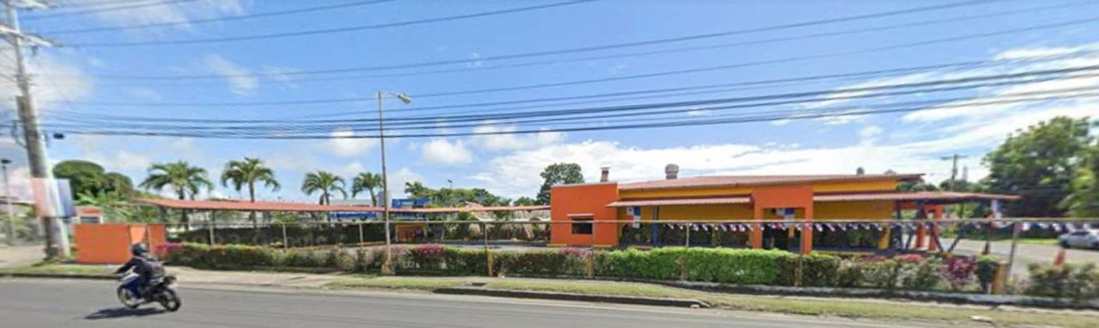 Bright commercial roadside building landscaped garden fenced perimeter Juan Díaz Panama for sale