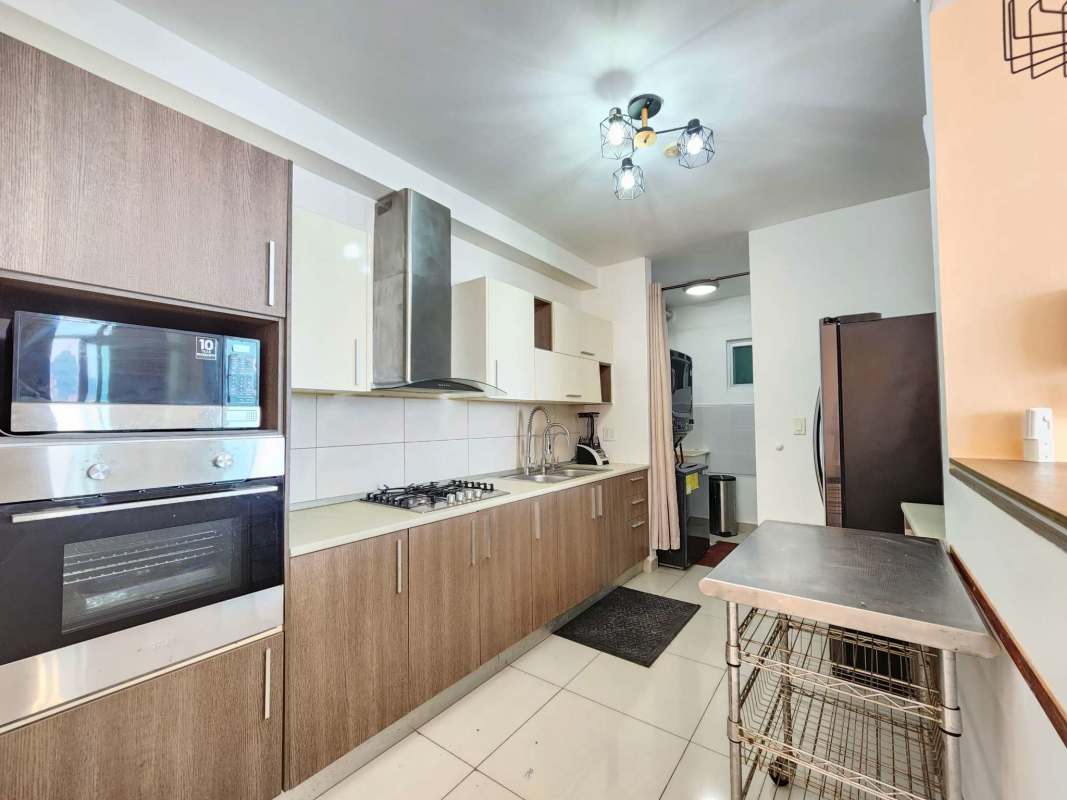 Kitchen with granite countertop, oven, microwave, stove in PH Torre Delta Vista Hermosa Panama