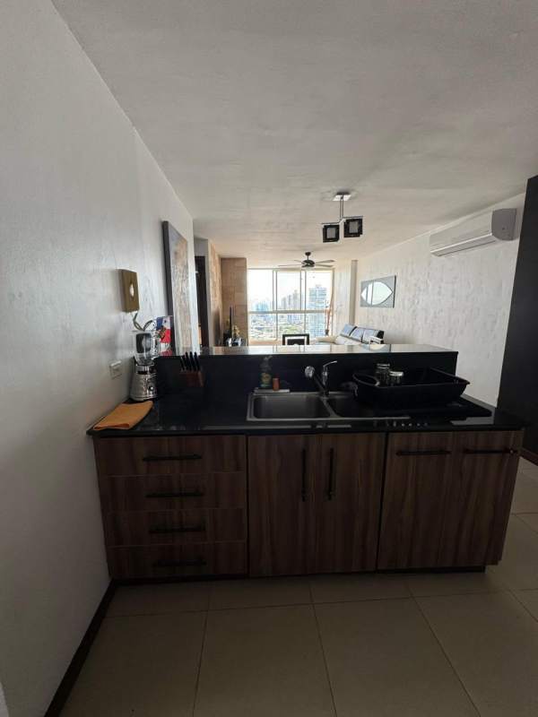 Modern open kitchen with appliances, granite counters, living dining area with city view PH Metric