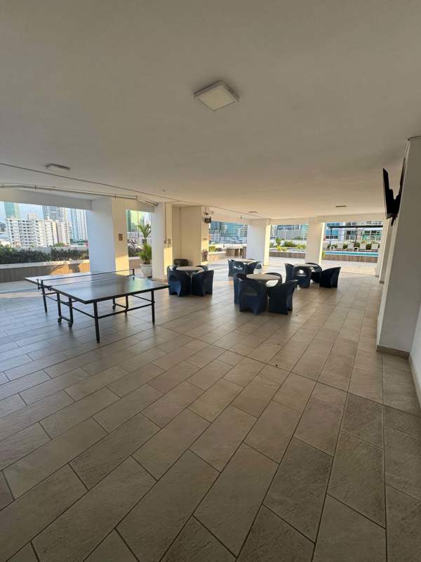 Covered outdoor area with ping pong, seating, skyline view in PH Metric Vía Brasil Panama