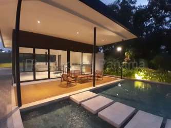 Modern kitchen and dining with sliding doors to balcony in new Costa Verde Panama condos