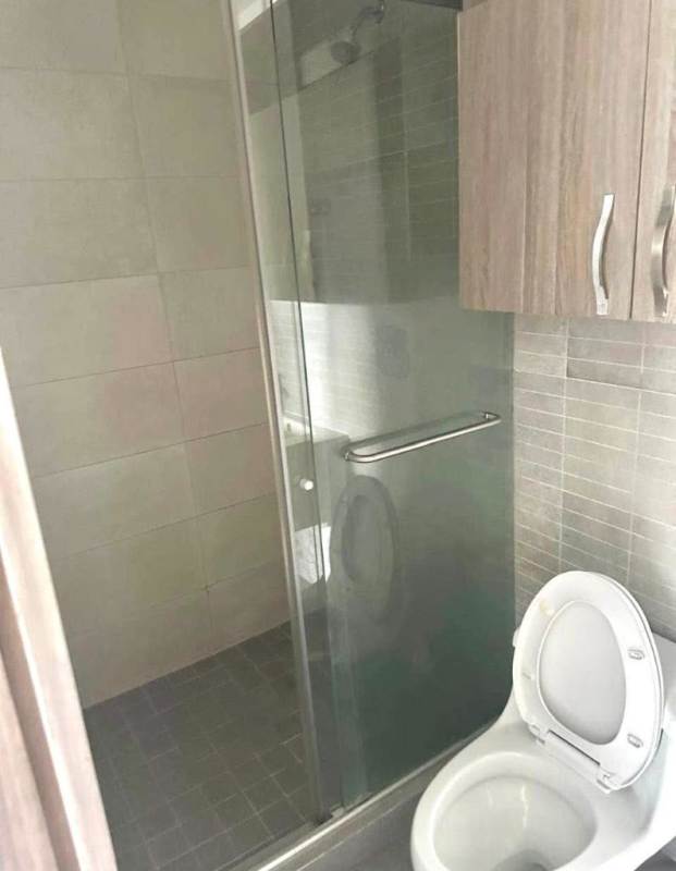 Contemporary bathroom with shower glass enclosure and wood cabinetry PH Loma Vista Tower Panama