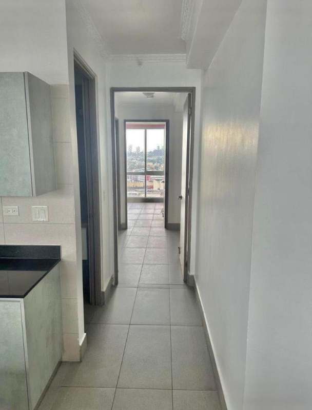 Walk-in closet with dark wood built-in shelving PH Loma Vista Tower Panama City