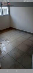 Empty minimalist bedroom with ceramic tile floor and window in new house Urbanización El Prado La Chorrera Panama